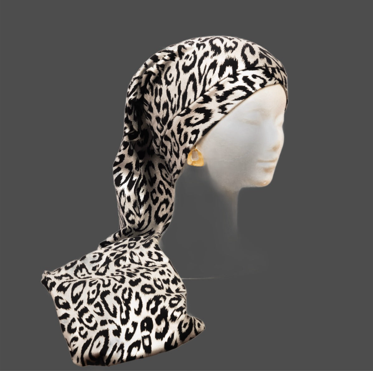 Leopard print Braid scarf on a mannequin head against a gray background. Hair care